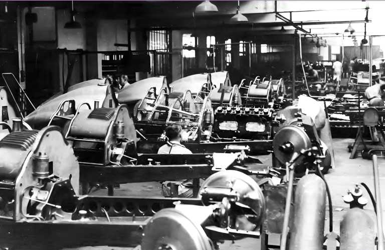 Rows of bare Talbot chassis and engines under assembly on the factory floor